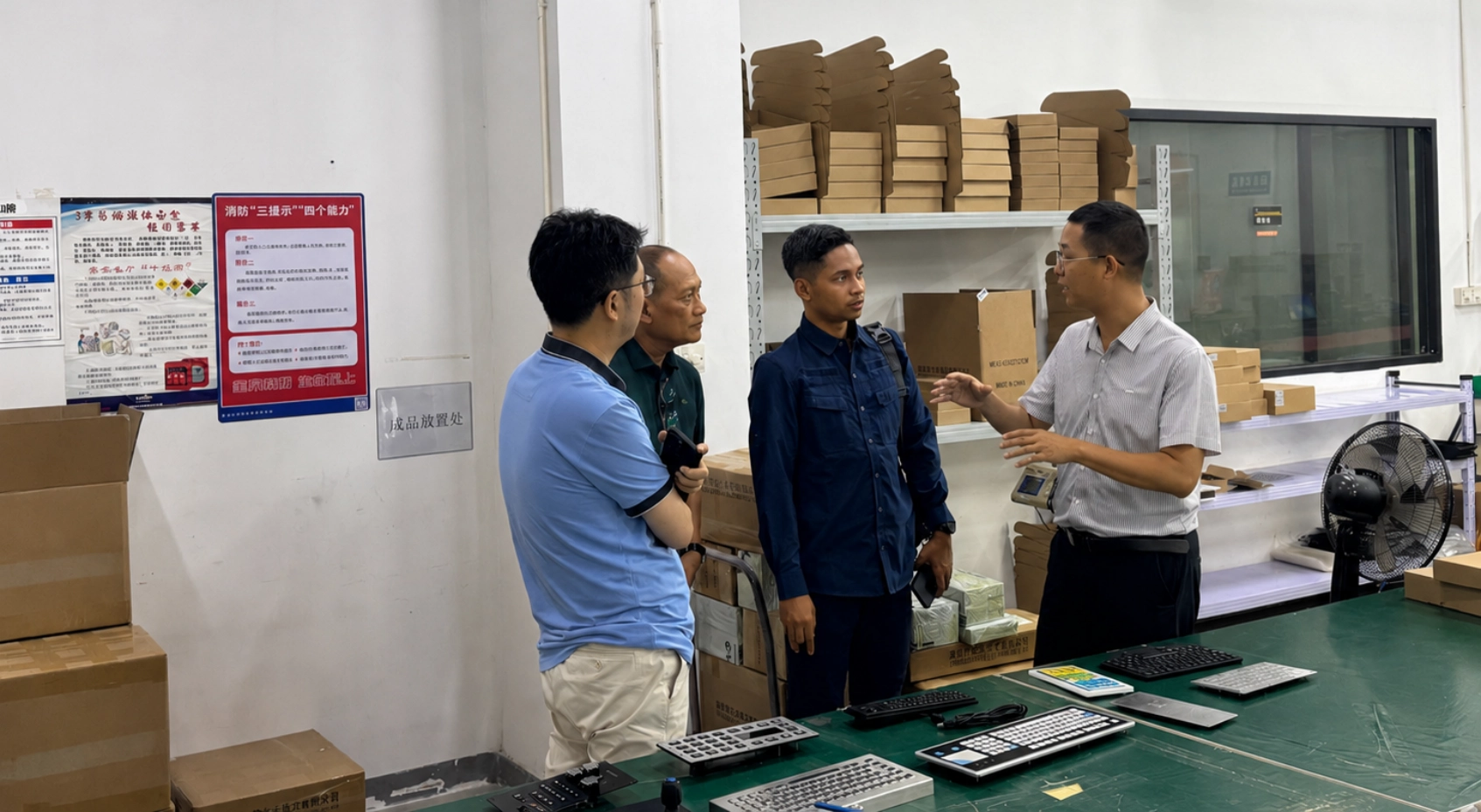 Customer discussing a customized keyboard project at the DAVOLIN production line